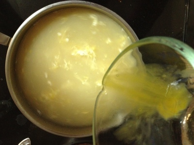 3.  Turn down heat on the broth and slowly pour eggs into it, stirring in circles with a fork until the eggs are distributed in streamers through the soup.  Top with green onions if desired.